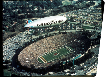 Goodyear Blimp Flying Over a Stadium