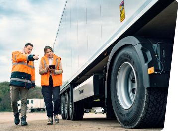 Goodyear tire technitions inspecting tires on a truck