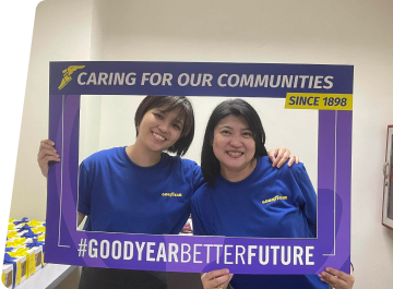 two volunteers holding sign