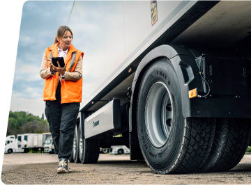 tech inspecting commercial tires