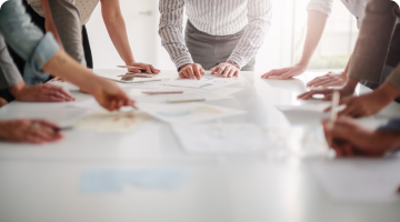 people strategizing around a table