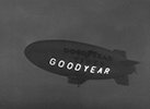 The Goodyear Tire & Rubber Company's blimp Defender became the first airship in the world to carry a lighted sign. Named Neon-O-Gram, 10 removable aluminum framed panels were attached to the side of the Defender allowing a static text to be displayed using neon light tubes. Each frame weighed 35 pounds and stood six feet tall and four feet wide.