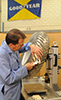 Rick Laske, project leader for The Goodyear Tire & Rubber Company's development of a replicate tire from NASA's Apollo space missions in the 1970s, checks tread plate widths of the wire-mesh structure. Goodyear-NASA's replicate tire includes four major components in the tire and wheel design: mesh, tread, inner-frame and hub. The mesh is woven from piano wire while the tread is a series of hinged metal strips which protect the mesh from impact, allowing for movement of the tire while maintaining flexibility, and providing increased contact area for floatation in the lunar soil. A team of Goodyear and NASA engineers created 12 replicate tires as part of a jointly funded project.